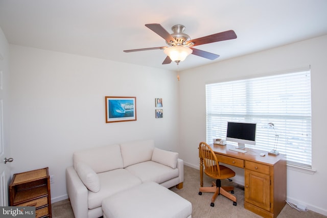 office area with light carpet, ceiling fan, and baseboards