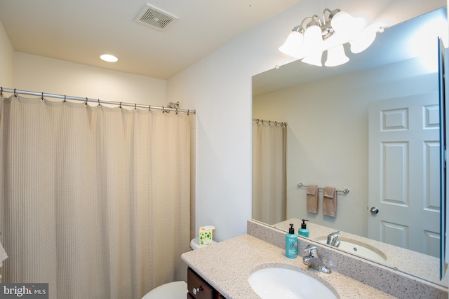 full bath featuring toilet, vanity, and visible vents