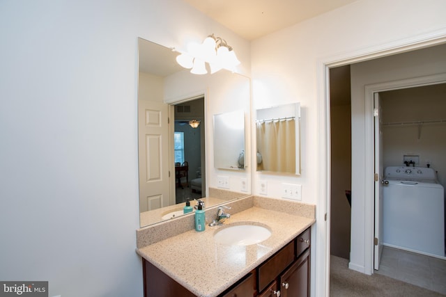 bathroom featuring washer / dryer and vanity