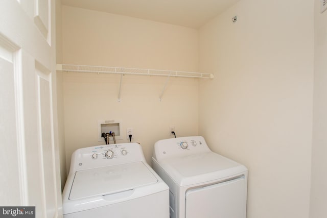 washroom featuring laundry area and washing machine and clothes dryer