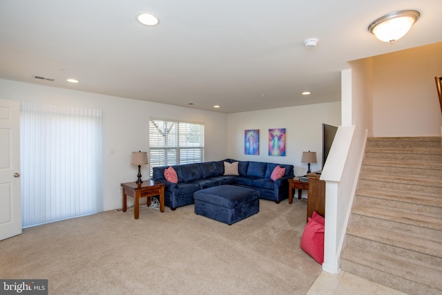 living room featuring recessed lighting, visible vents, light colored carpet, and stairway