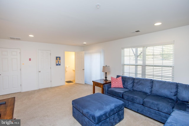 carpeted living room with baseboards, visible vents, and recessed lighting