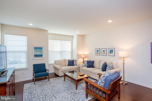 living room with baseboards, wood finished floors, and recessed lighting