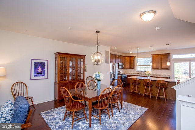 dining space with dark wood-style floors, baseboards, a notable chandelier, and recessed lighting