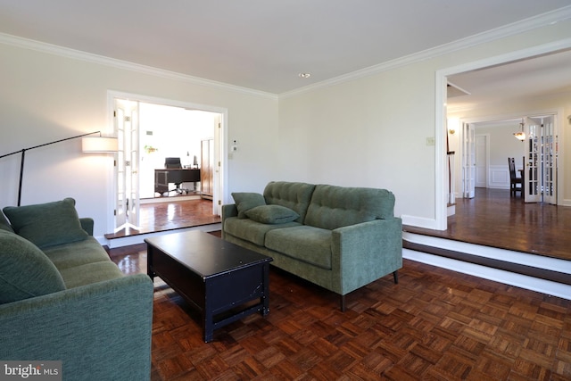 living room with ornamental molding and baseboards