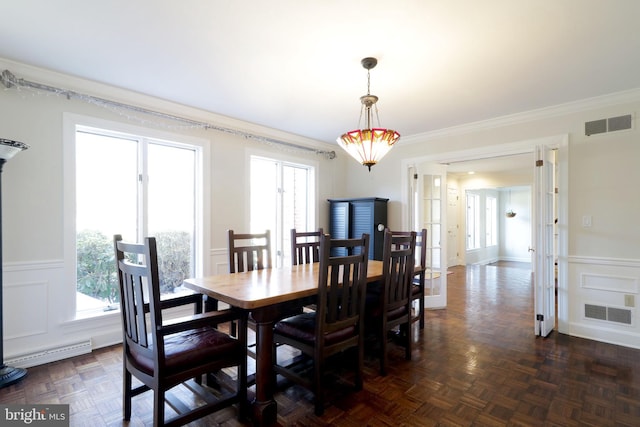 dining space with a decorative wall, visible vents, and a healthy amount of sunlight