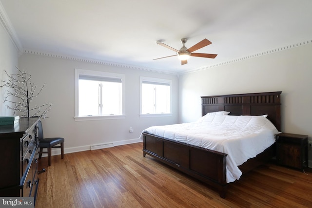 bedroom with baseboards, visible vents, ceiling fan, ornamental molding, and wood finished floors