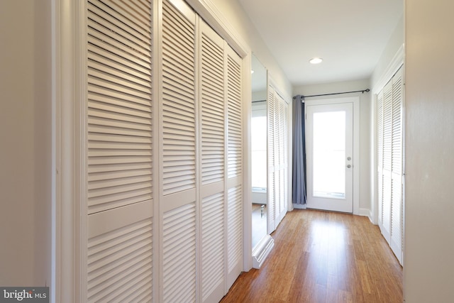 entryway with wood finished floors and recessed lighting