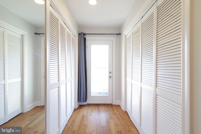 entryway with light wood finished floors and baseboards