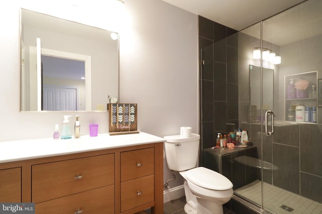 full bath featuring a stall shower, vanity, and toilet