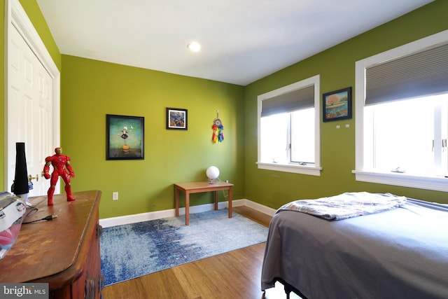 bedroom featuring baseboards and wood finished floors