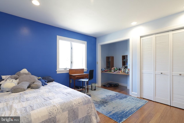 bedroom featuring recessed lighting, a closet, baseboards, and wood finished floors