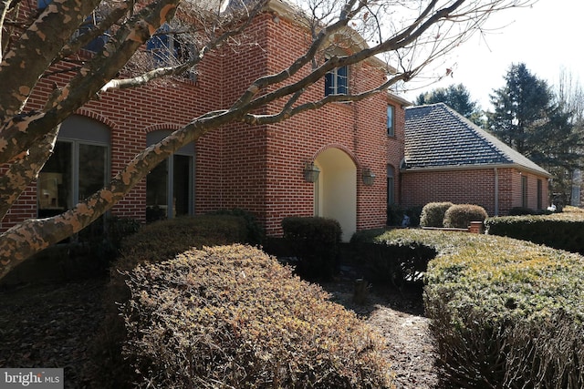 view of side of home featuring brick siding