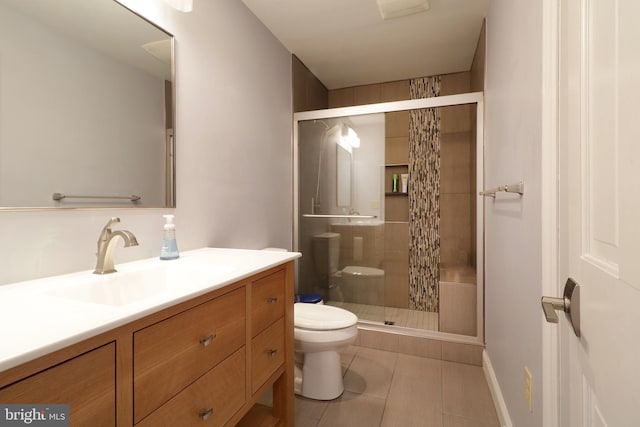 bathroom featuring toilet, a stall shower, tile patterned flooring, and vanity