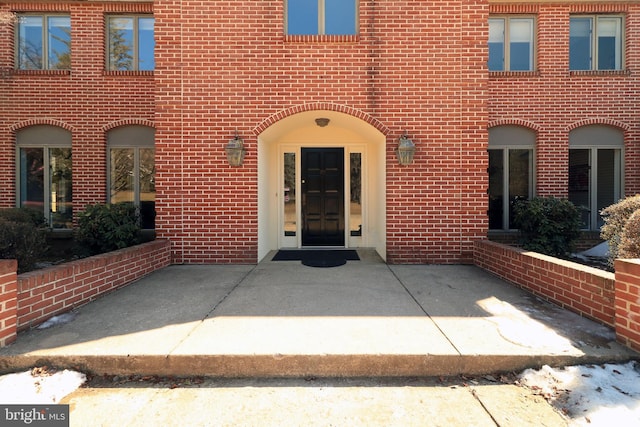 property entrance featuring brick siding