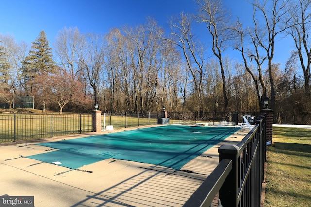 view of swimming pool featuring a patio, fence, and a fenced in pool