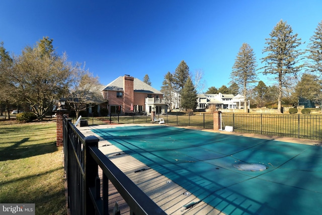 view of pool with a yard, fence, and a fenced in pool