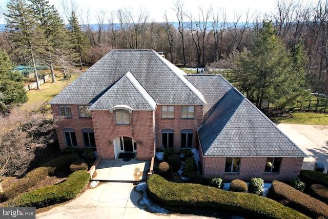 colonial house featuring brick siding