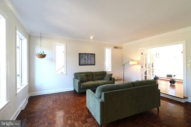 living area with a healthy amount of sunlight, visible vents, and crown molding