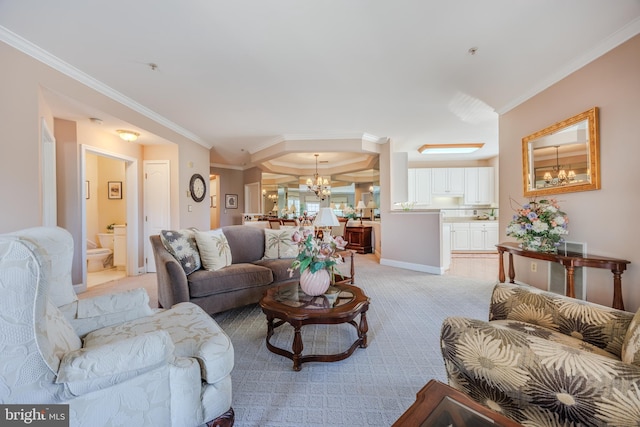 living room featuring light carpet, crown molding, baseboards, and a notable chandelier