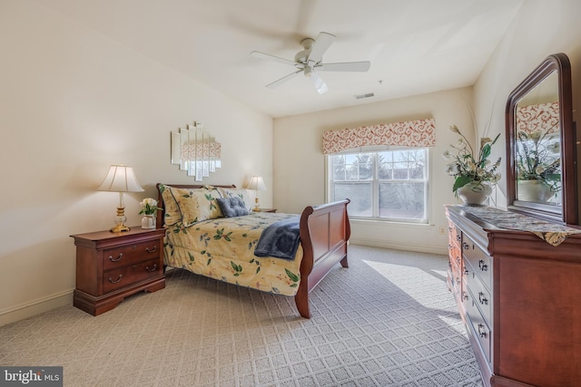 bedroom with baseboards, visible vents, ceiling fan, and light colored carpet