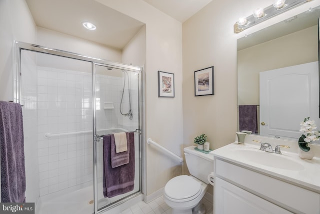 full bath featuring toilet, a stall shower, vanity, tile patterned flooring, and baseboards