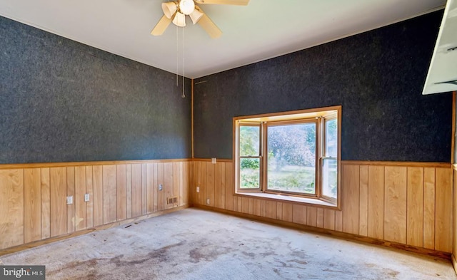6621 Schoolhouse Rd, Bealeton, VA 22712 - empty room featuring ceiling fan, carpet floors, wooden walls, and wainscoting