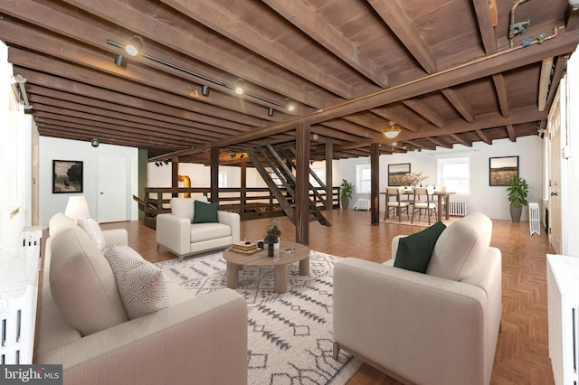 living area featuring stairs, beamed ceiling, and radiator heating unit