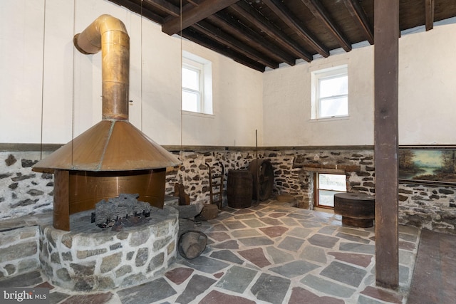 interior space with beam ceiling and stone floors