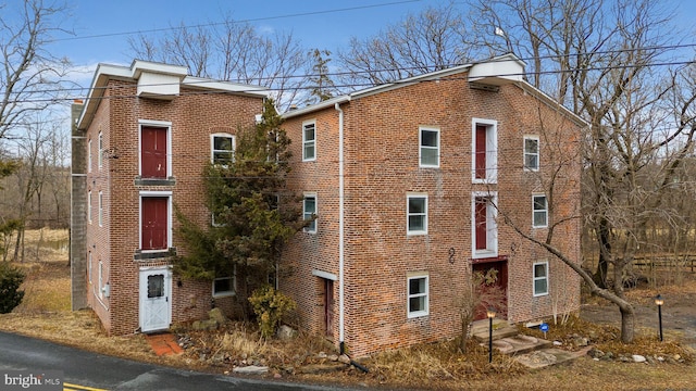 view of side of property featuring brick siding