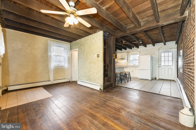 unfurnished room featuring baseboard heating, beamed ceiling, wood ceiling, and wood-type flooring