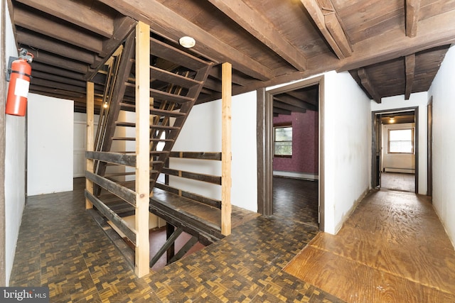 below grade area featuring stairway, baseboard heating, and a baseboard heating unit