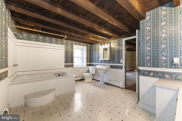 bathroom with wallpapered walls, a baseboard heating unit, beamed ceiling, toilet, and wainscoting