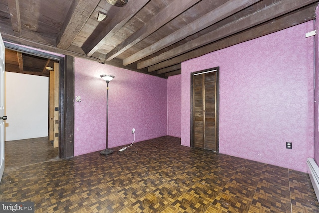 below grade area featuring a baseboard heating unit and parquet floors