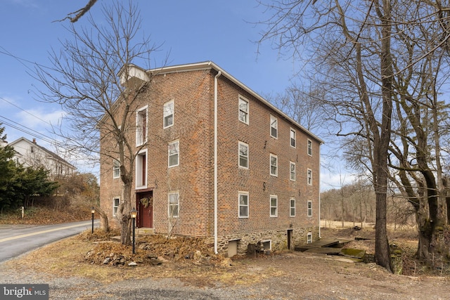 view of property exterior featuring brick siding