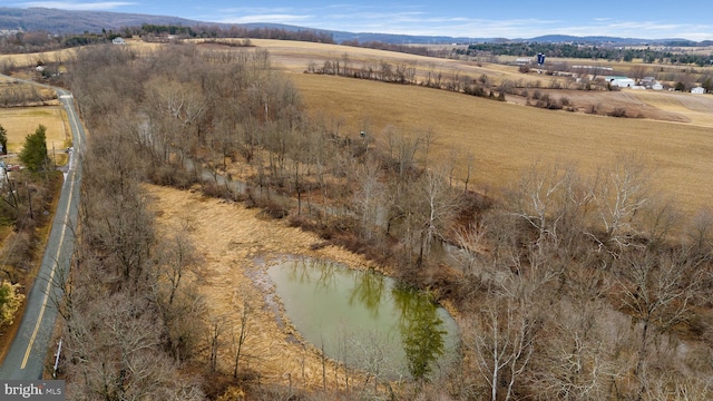 birds eye view of property featuring a rural view and a water and mountain view