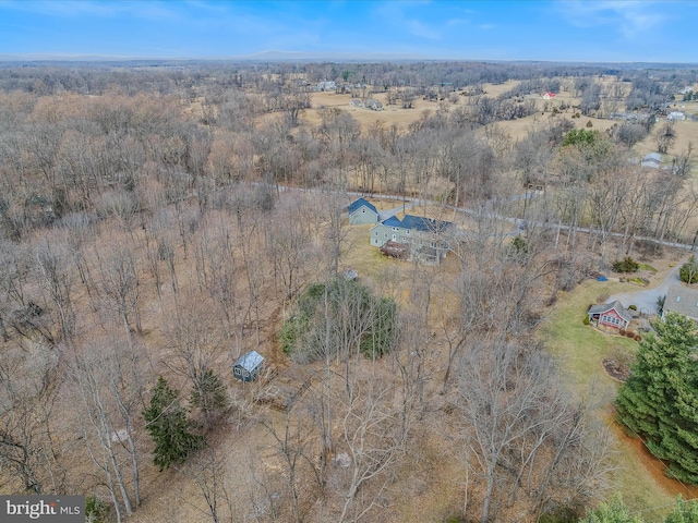 birds eye view of property with a view of trees