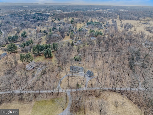 birds eye view of property featuring a wooded view