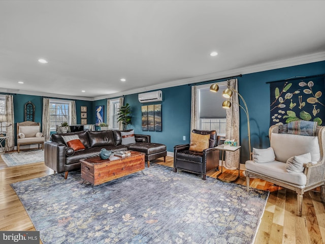 living area featuring an AC wall unit, recessed lighting, wood finished floors, and crown molding