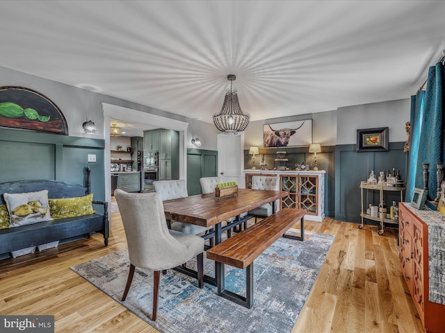 dining area featuring wainscoting and wood finished floors