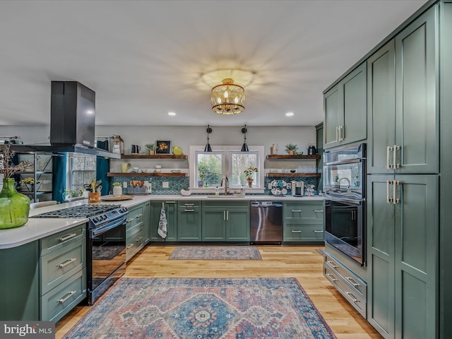 kitchen featuring green cabinets, open shelves, light countertops, and stainless steel appliances