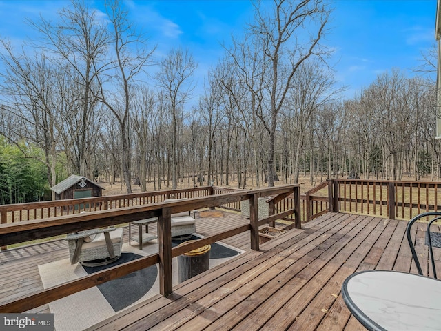 deck with an outbuilding and a shed