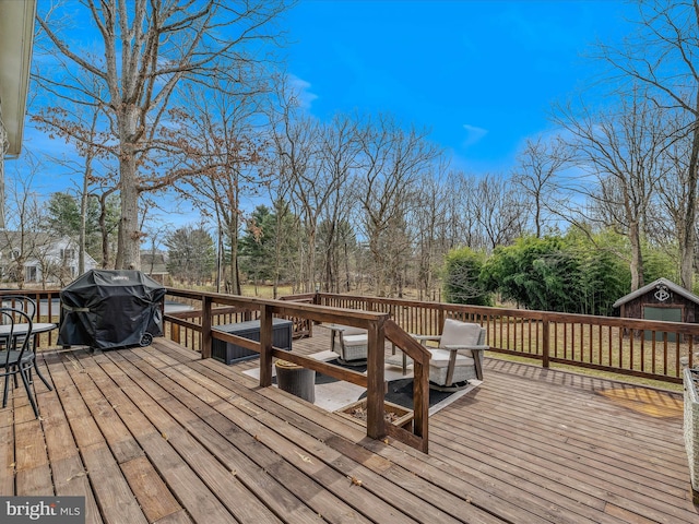 deck featuring grilling area and an outbuilding