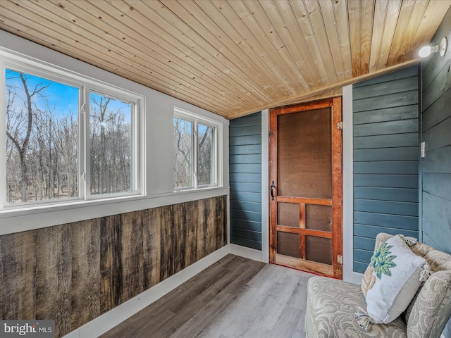 unfurnished sunroom featuring lofted ceiling and wood ceiling