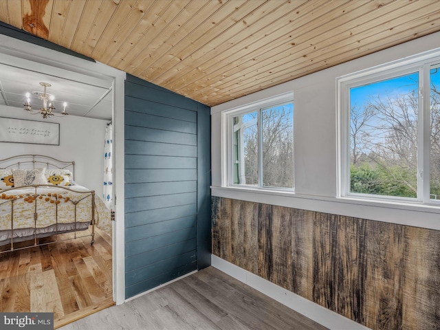 unfurnished sunroom with wood ceiling and a notable chandelier