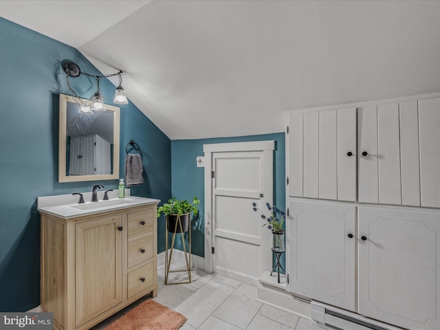 bathroom featuring lofted ceiling, vanity, baseboards, marble finish floor, and baseboard heating