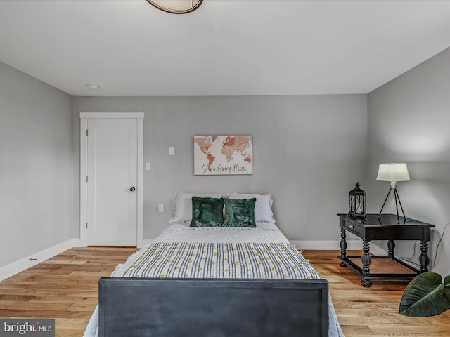 bedroom featuring baseboards and wood finished floors