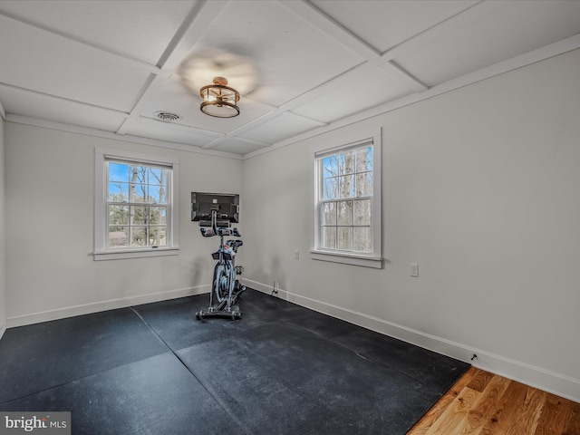 workout area featuring a wealth of natural light, coffered ceiling, visible vents, and baseboards