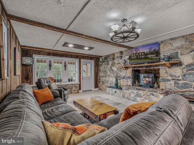 living area featuring a chandelier, wood finished floors, beam ceiling, and wooden walls