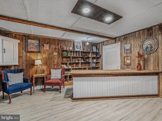 interior space with wooden walls and wood finished floors